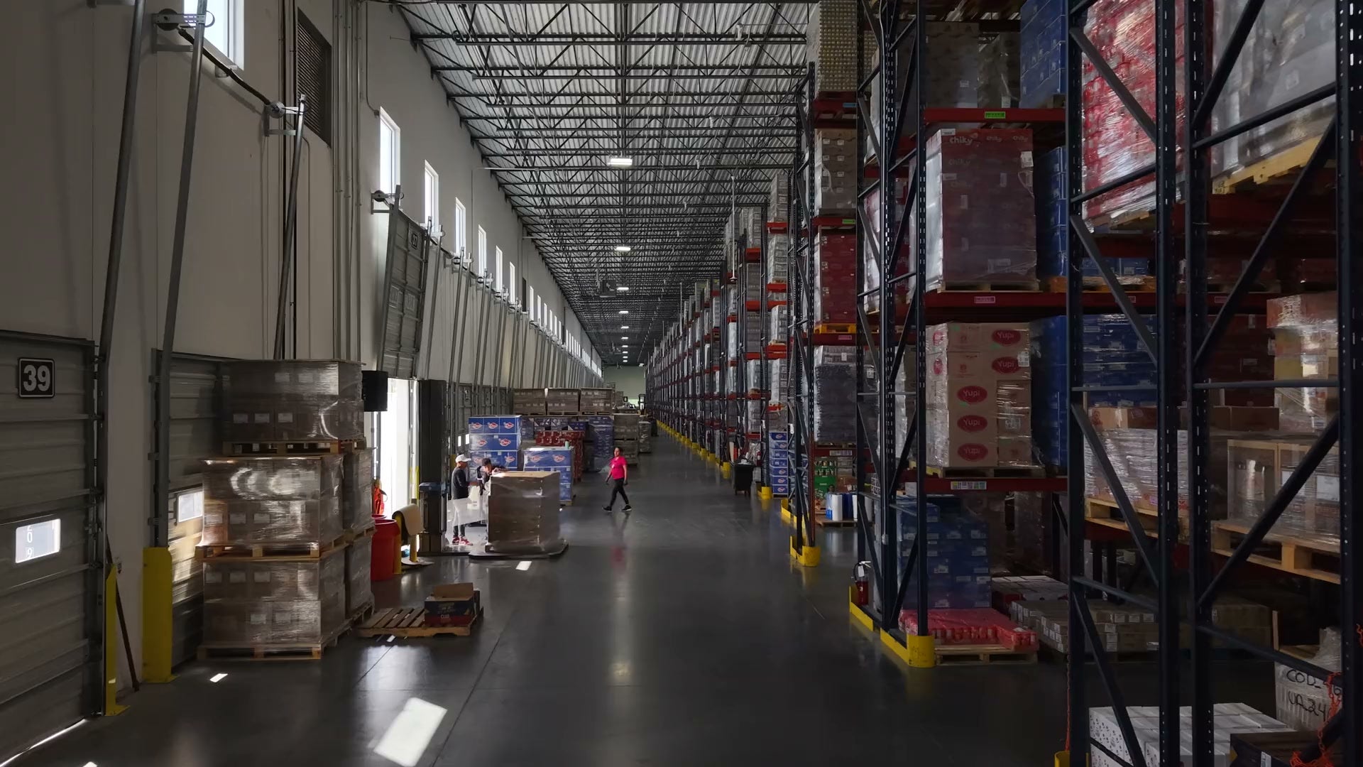 SaborCol warehouse aisle stocked with Colombian food pallets